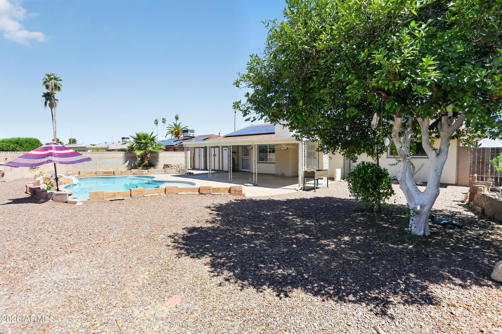 Backyard with private pool and covered patio at 10613 W Meade Dr
