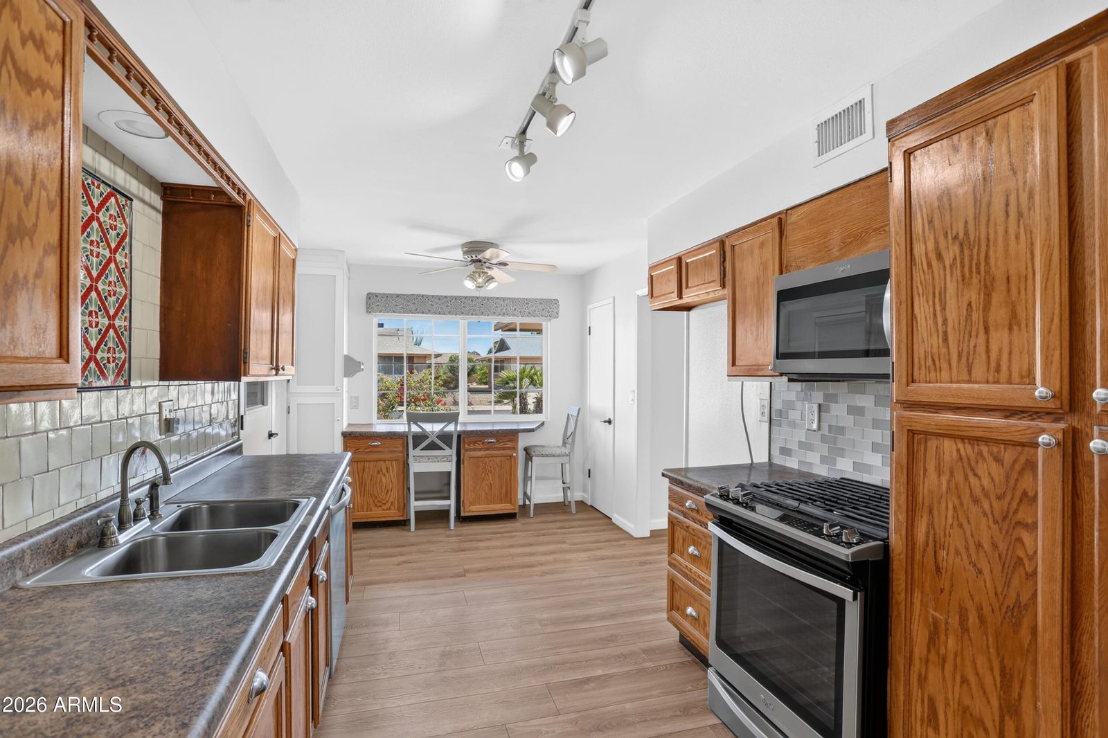 Kitchen with gas range and breakfast area at 10613 W Meade Dr
