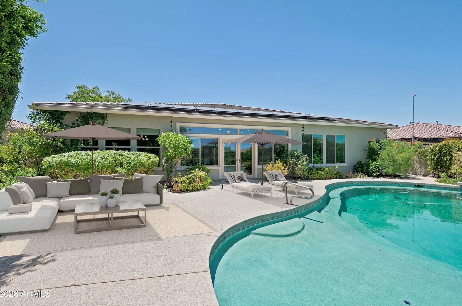 Covered patio and pool lounge area in a Litchfield Park, Arizona brokerage listing